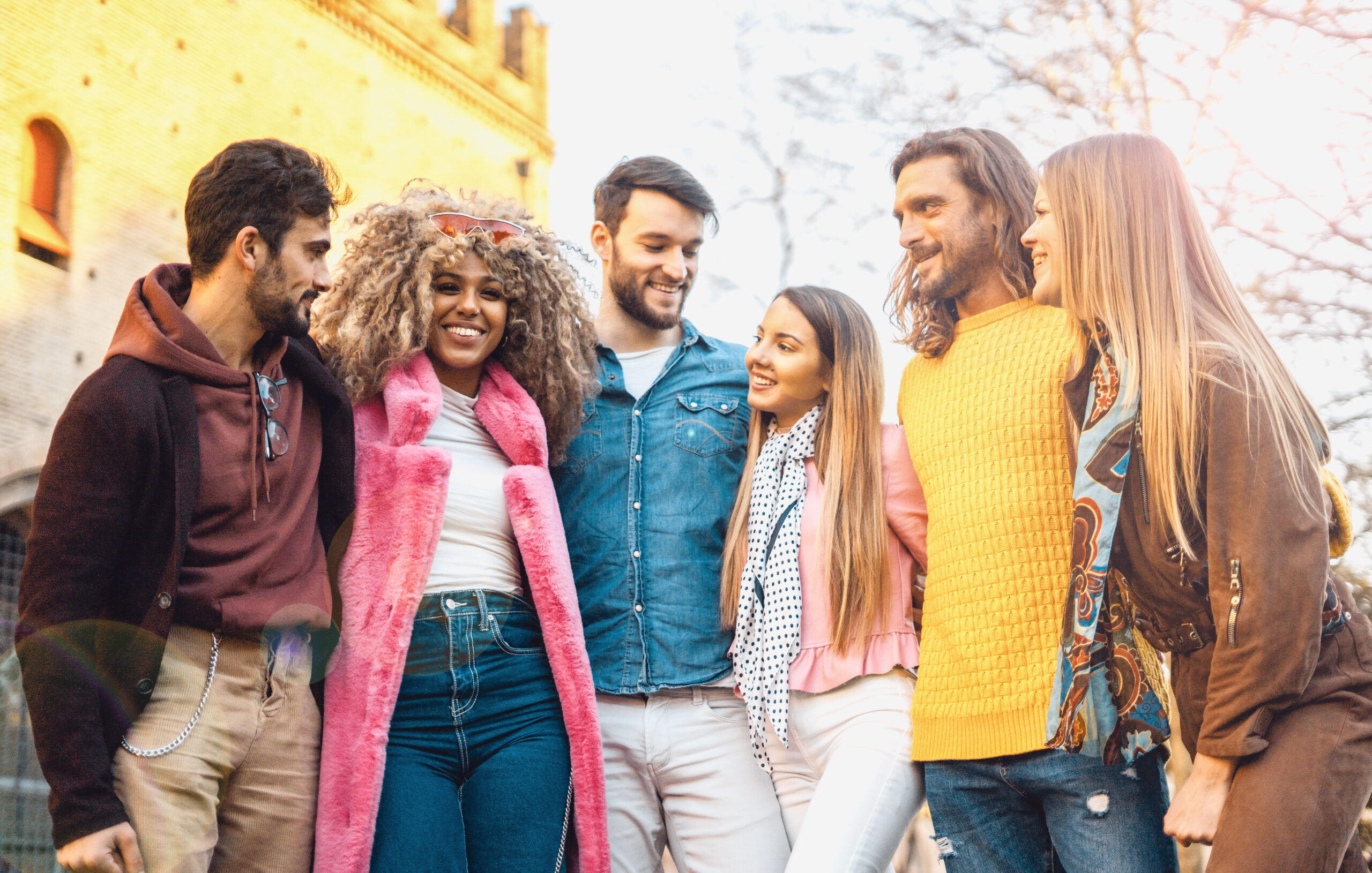 group of young people having fun together having free time in an outdoor environment. Vivid image, filtered.